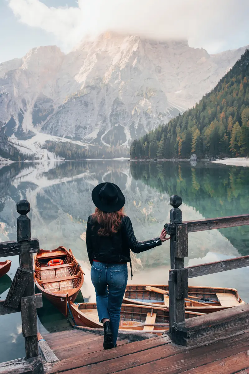 Woman In Black Hat Near The Lake With Boats
